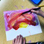 A child illustrates a sunrise as a part of a space and sky inquiry. 